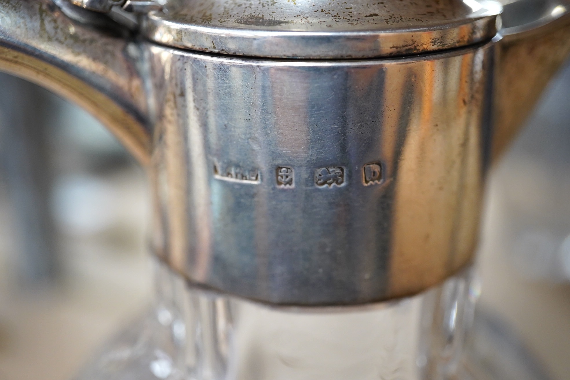 An Edwardian silver mounted glass claret jug, William Henry Leather, Birmingham, 1901, 25.3cm. Condition - poor